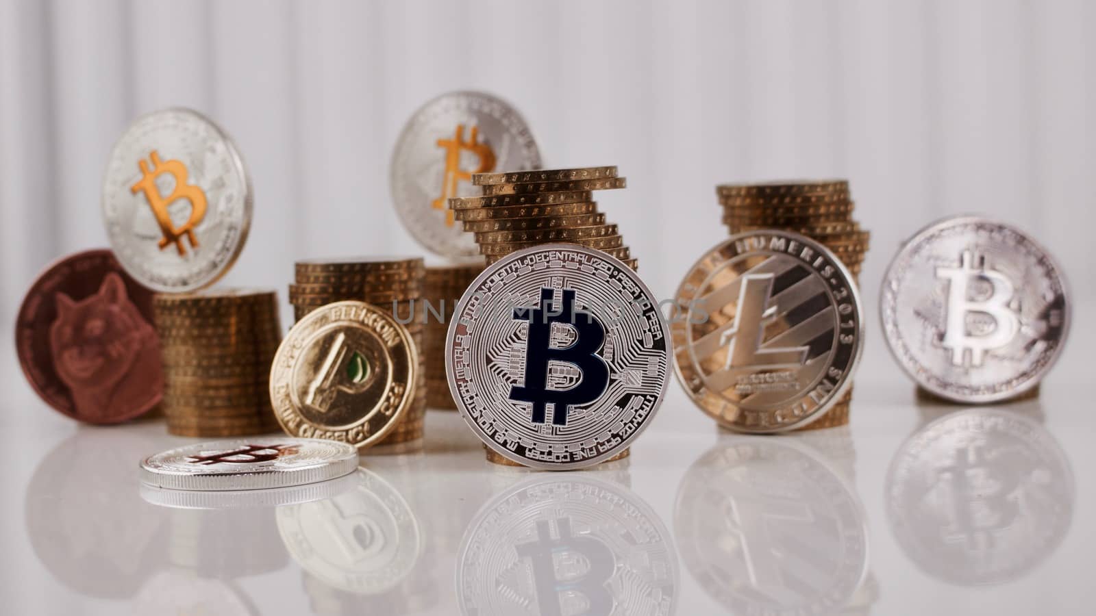 Digital currency physical silver bitcoin coin near gold money on the table.