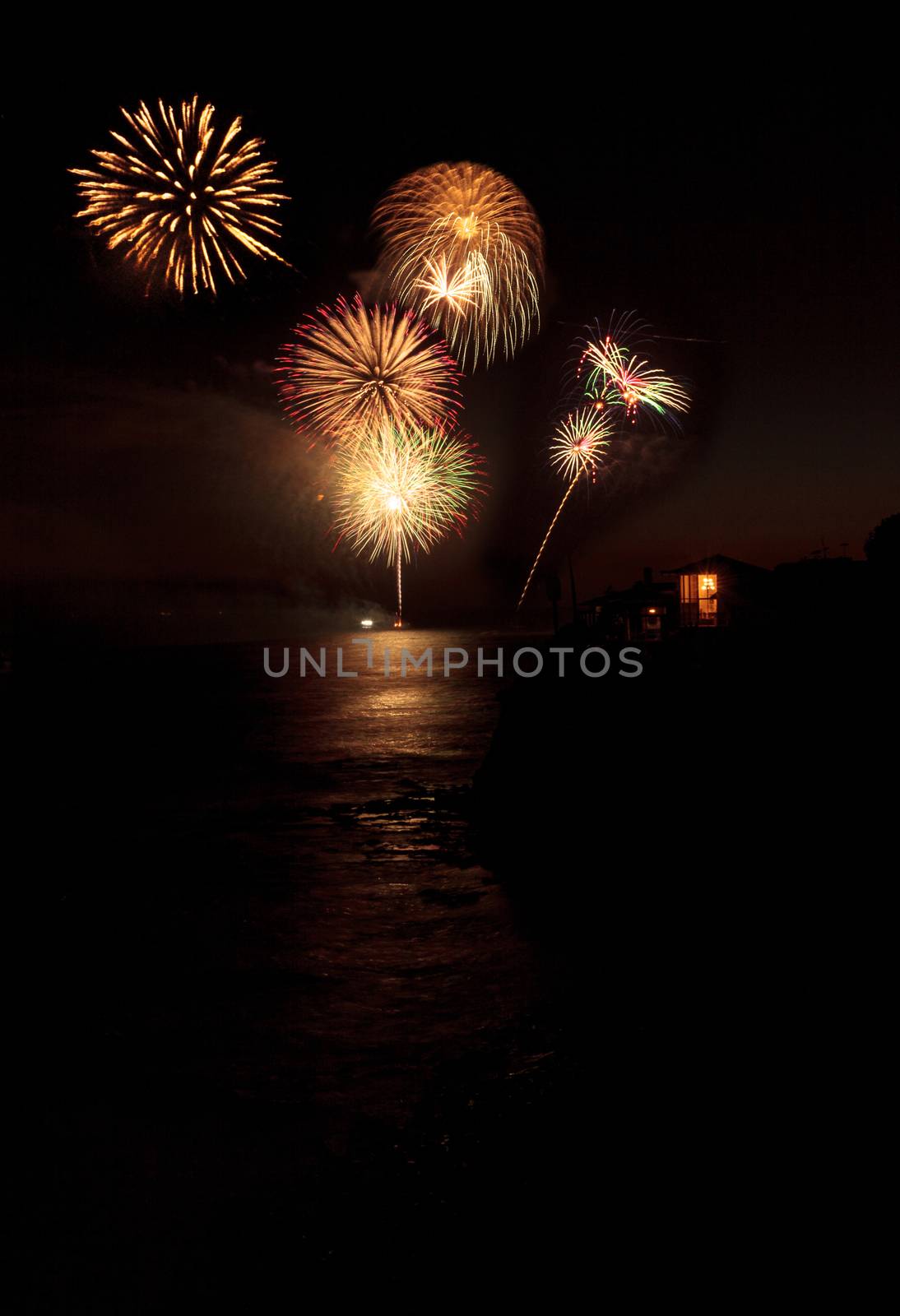 Laguna Beach, CA, USA - July 4, 2017: Colorful explosion of fireworks over the Emerald Bay beach in Laguna Beach.