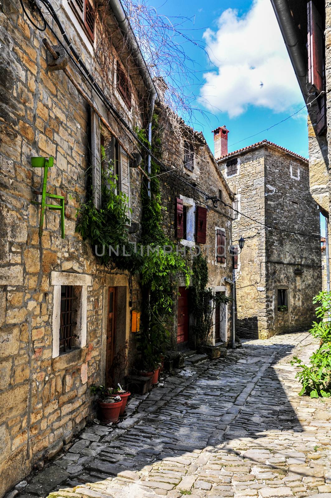 Old medieval town with stone paved roads by asafaric