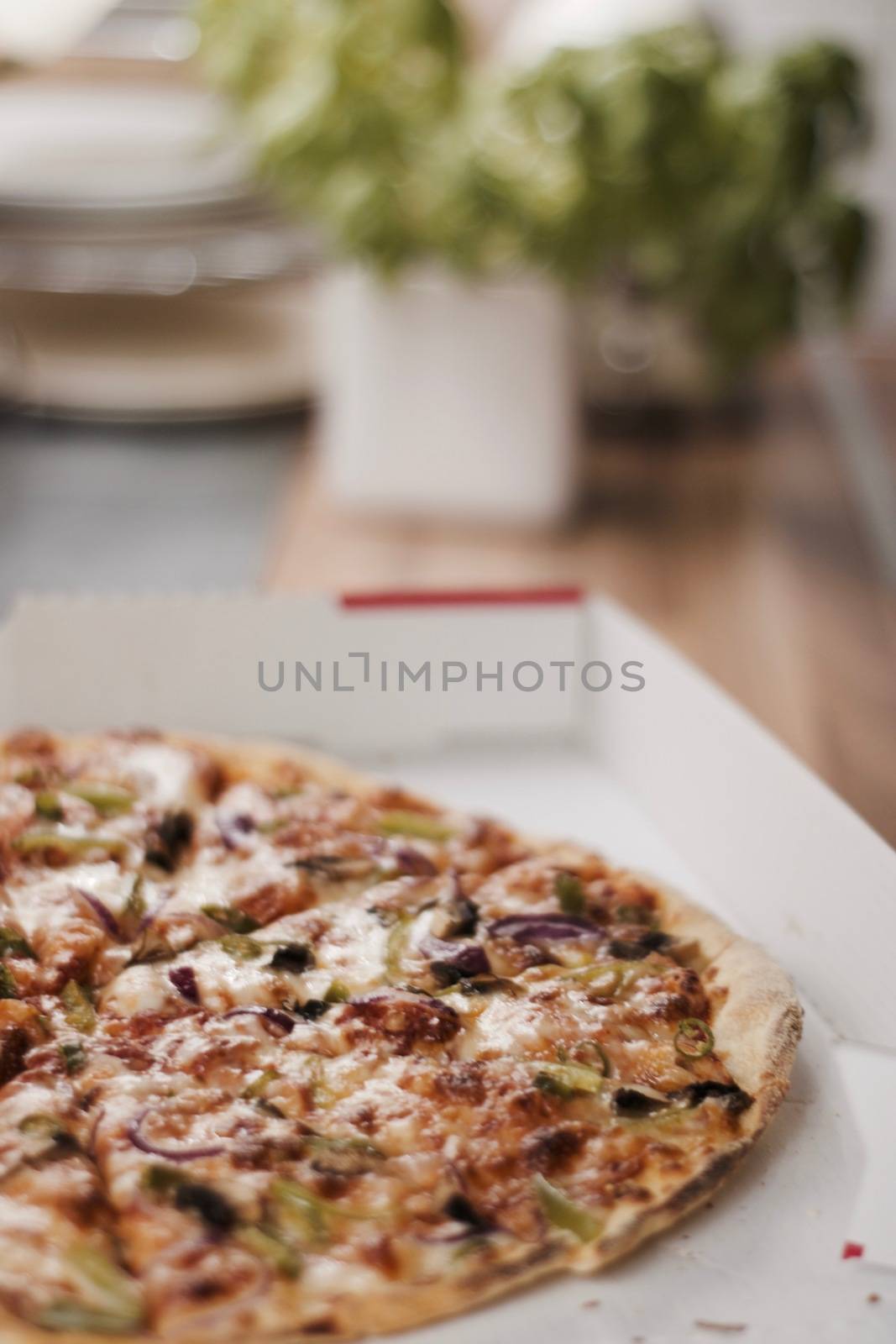 Fresh and tasty vegetarian spicy pizza in the kitchen. Fast food concept.