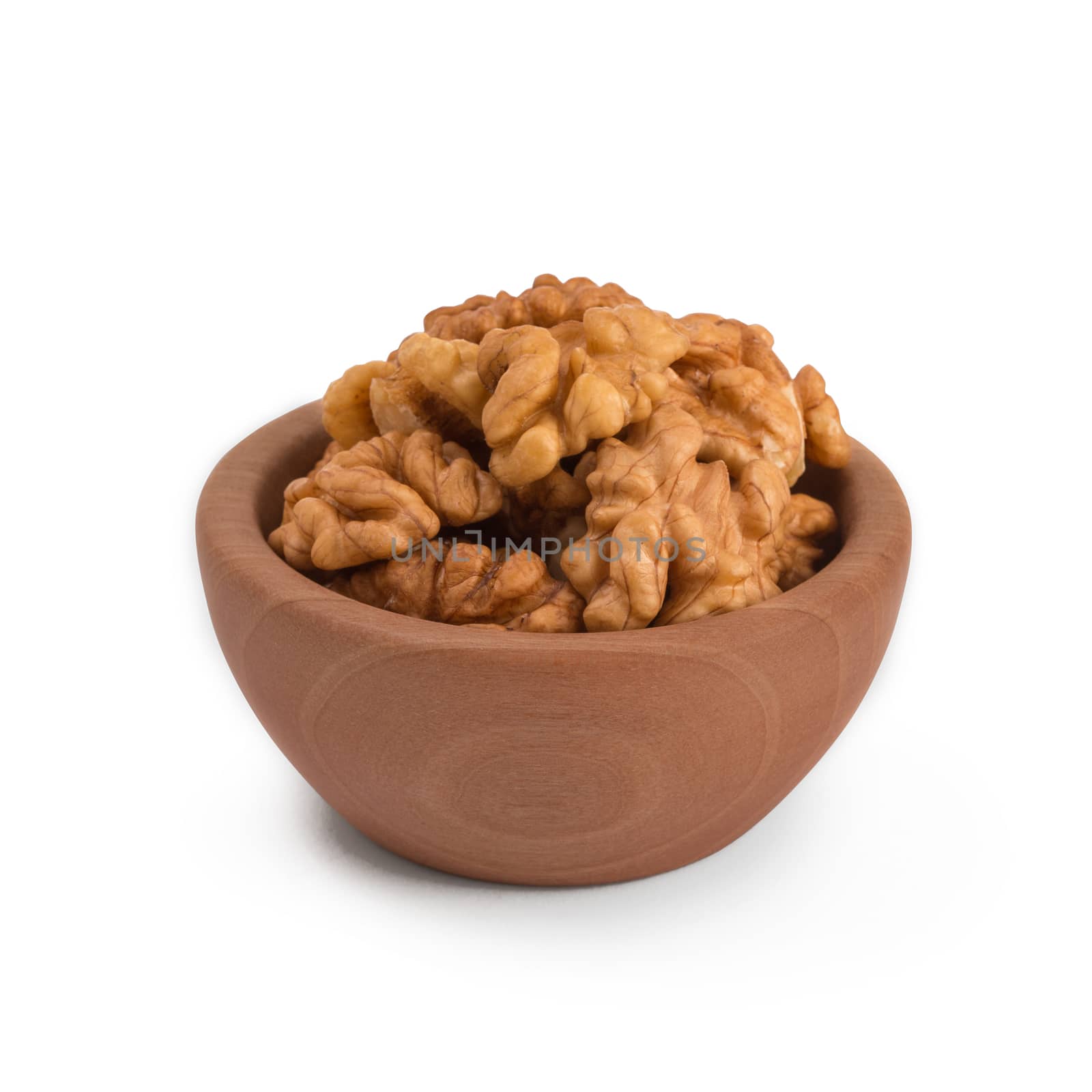 Walnuts shelled in a bowl isolated on white background. Side view. Walnut kernels in a bowl