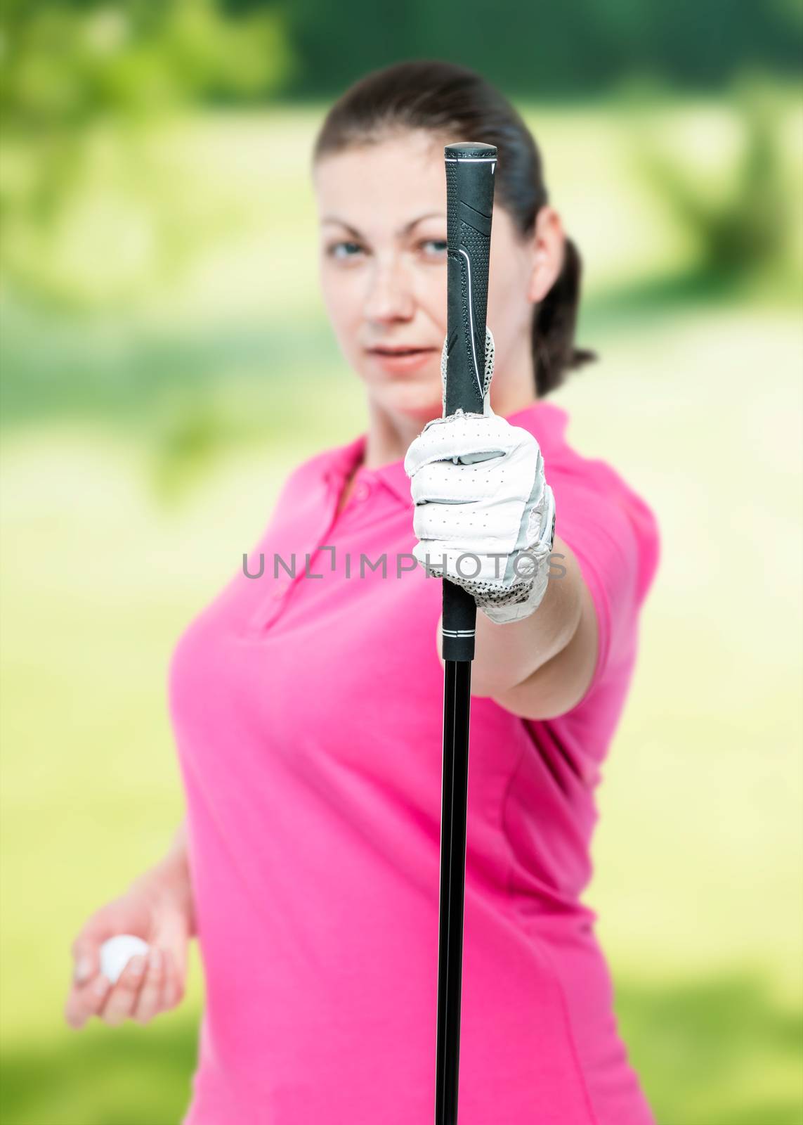 athlete shows a golf club at the camera on a background of golf by kosmsos111