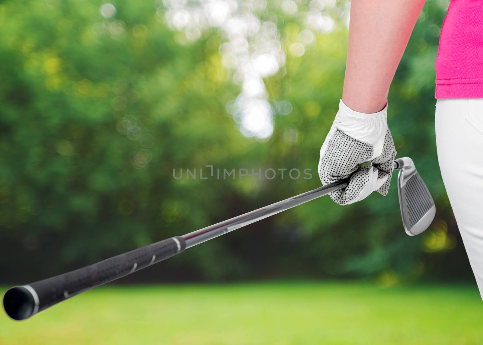 golf clubs close up in hands the athlete on a background of golf courses