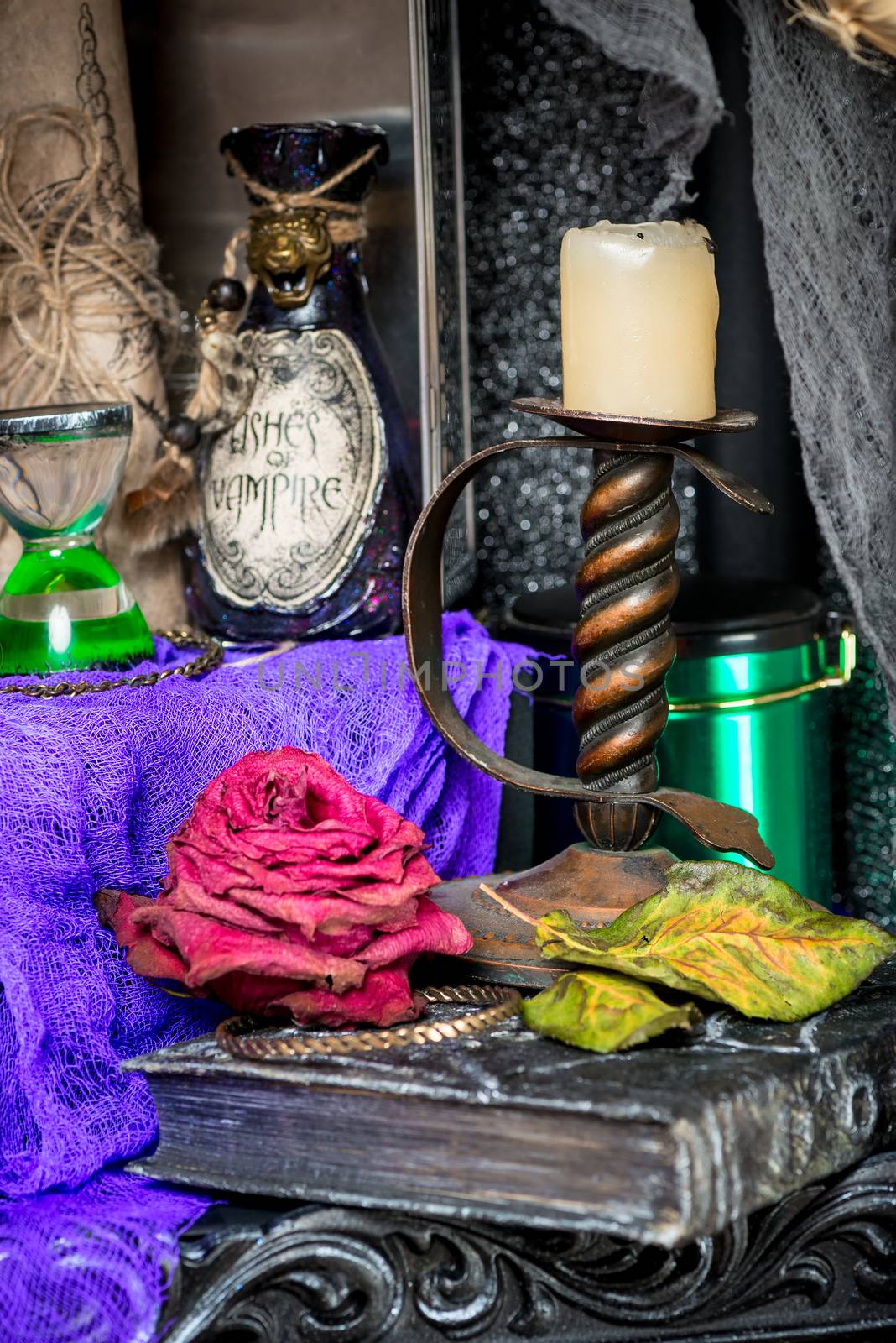 candlestick closeup on a table with a witch's props for rituals
