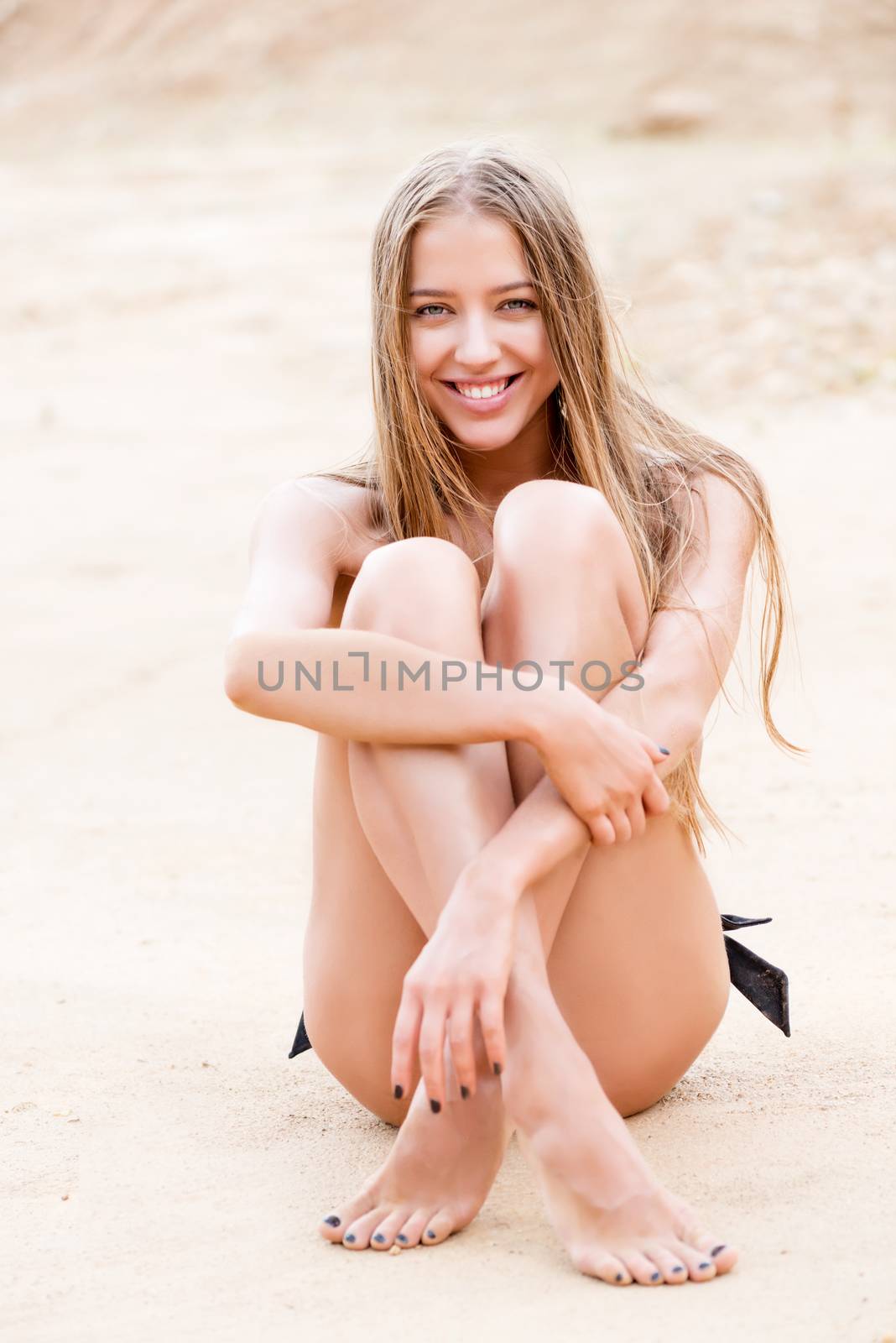 girl with beautiful skin posing sitting on the sand in a bikini by kosmsos111