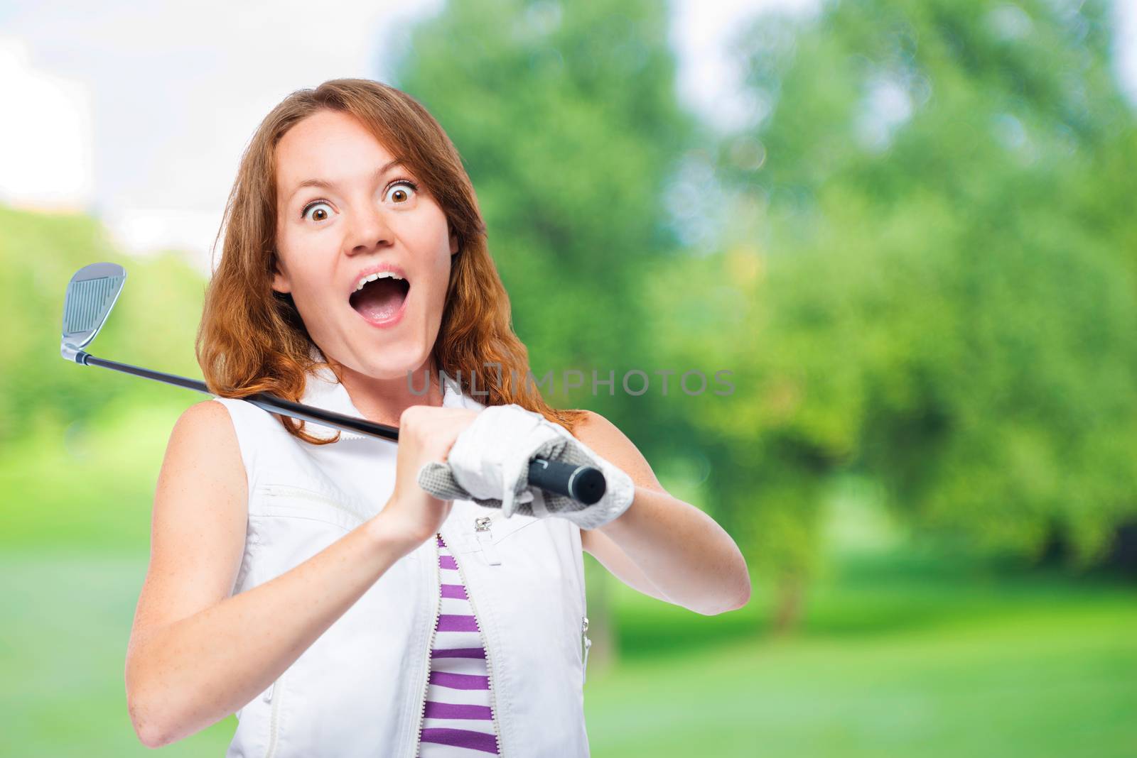 Shocked golfer looking behind the trajectory of a ball flying on a background of golf courses