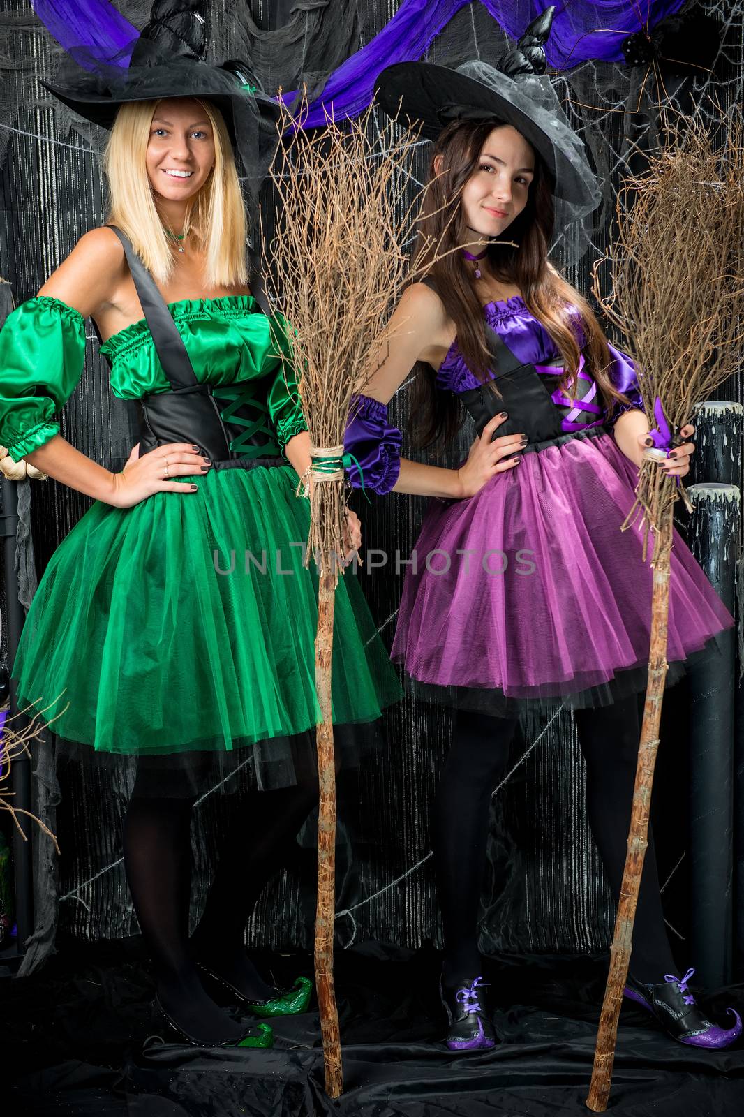vertical portrait of two enchanting witch with brooms to hallowe by kosmsos111