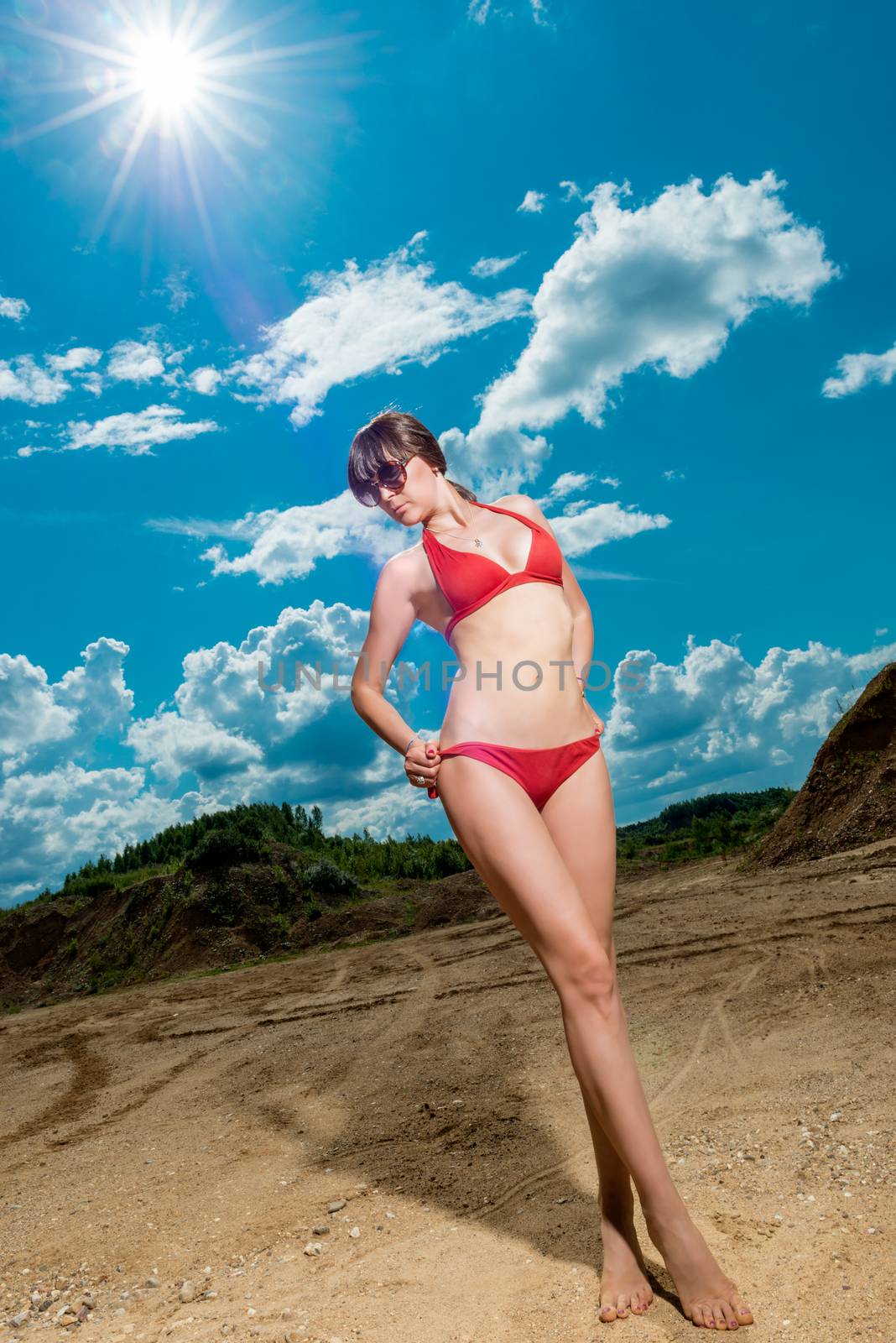 brunette in a red bikini on a sunny day in the sand by kosmsos111