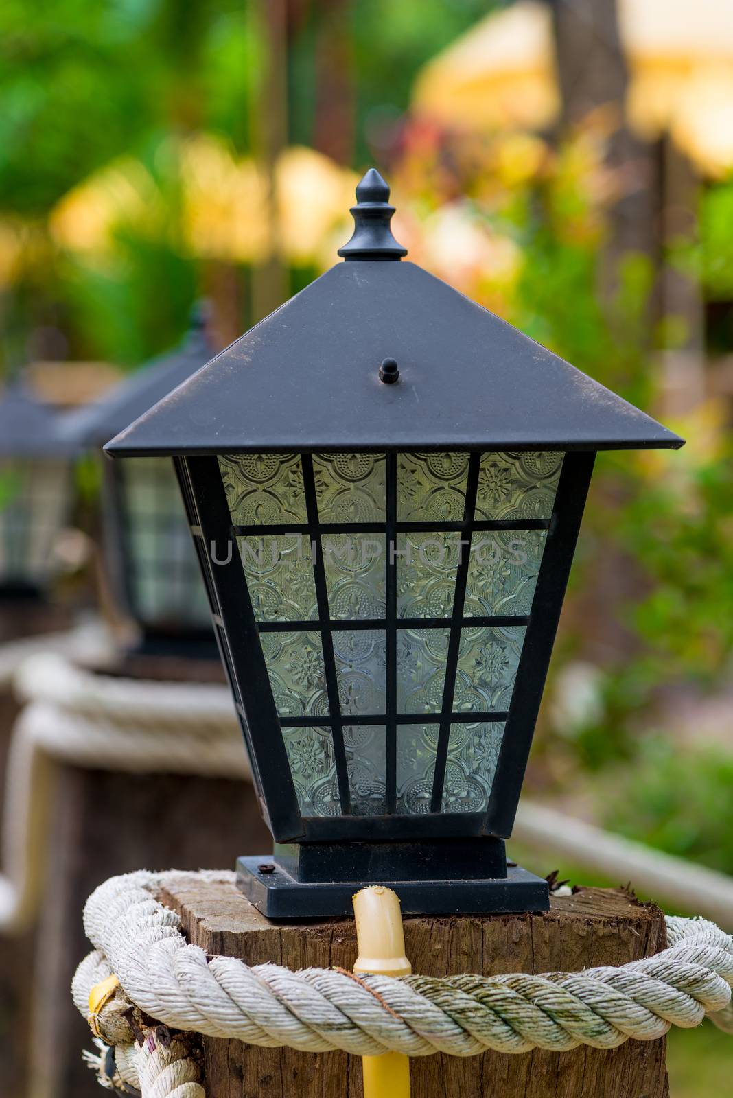 lantern in retro style of metal and glass close-up on the street by kosmsos111