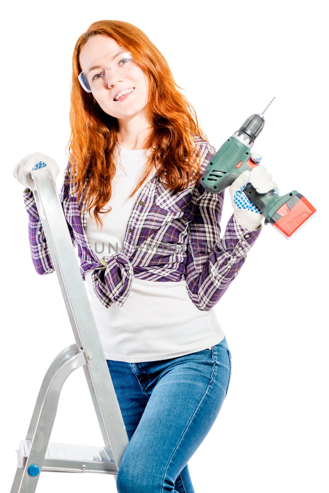 beautiful girl with red hair on a stepladder with a drill pose