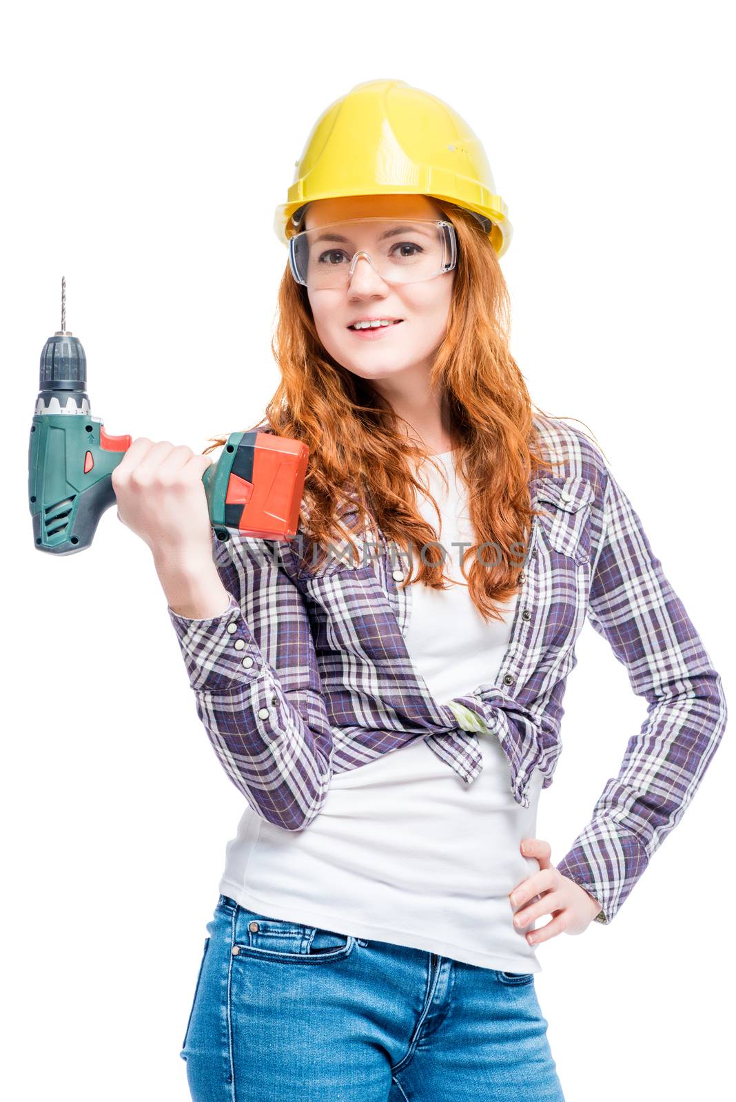 Slim beautiful woman with a drill in protective clothing ready t by kosmsos111