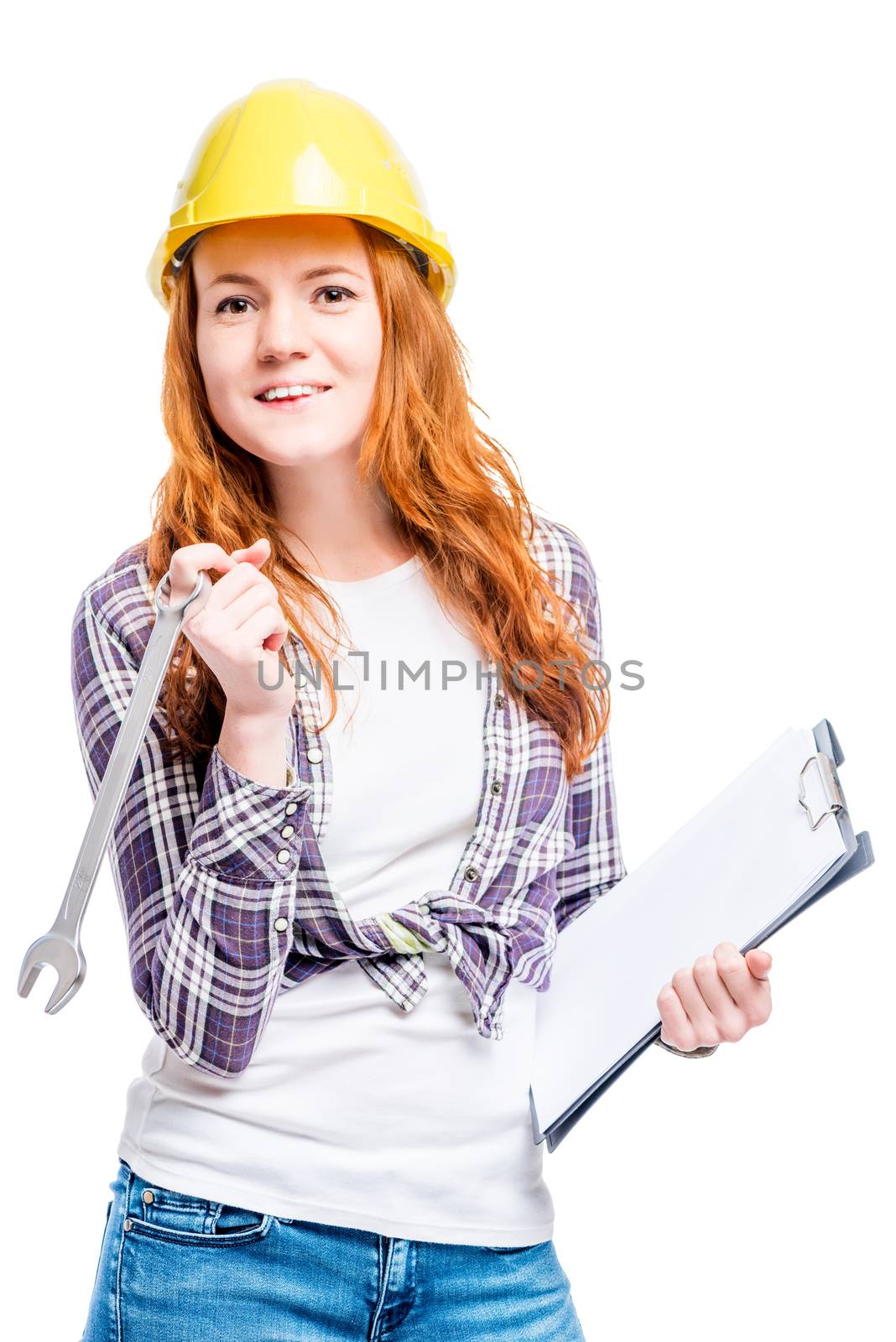 isolated portrait of a woman with tools in a yellow hard hat