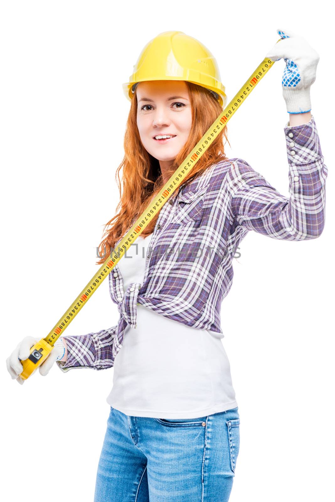 beautiful girl with a tape measure and a yellow hard hat on a white background