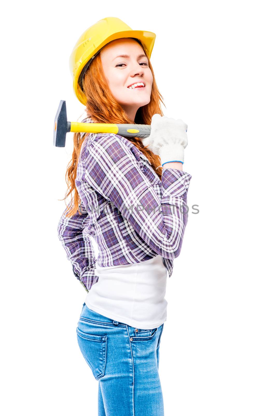 successful woman with a hammer in a yellow hard hat against a wh by kosmsos111