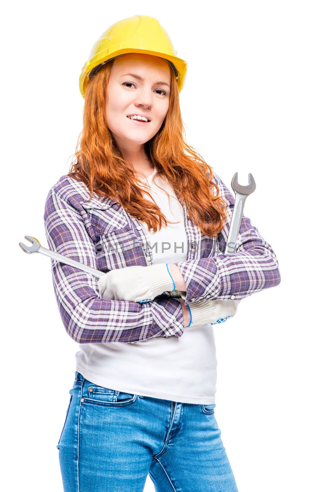 vertical portrait of a woman in a helmet with mechanic keys on a white background