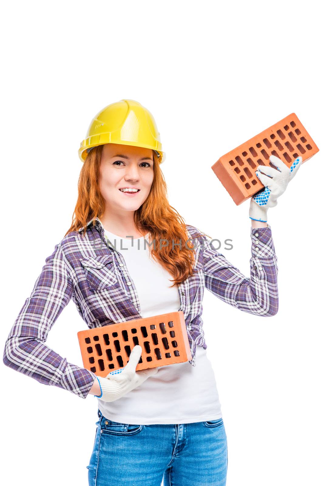 strong woman builder in yellow breeze with bricks on white background