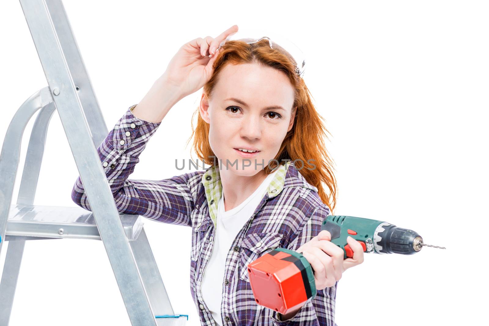 girl with electric drill-screwdriver on a white background