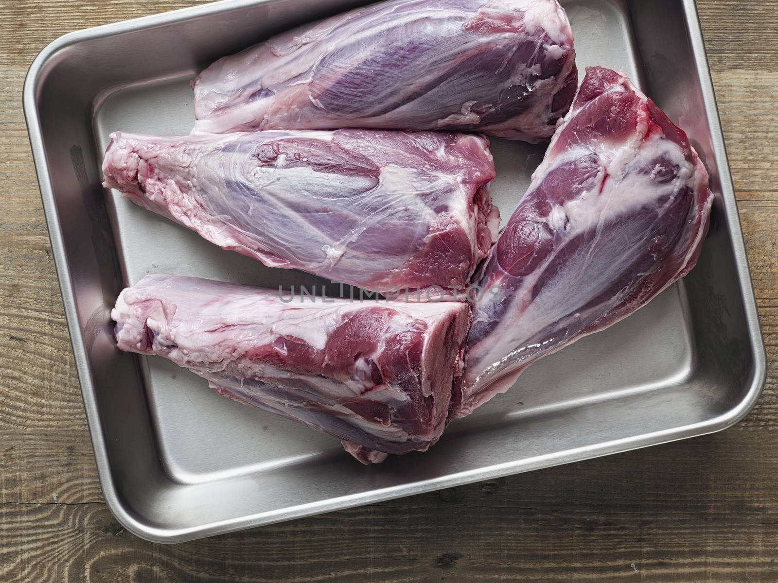 rustic uncooked lamb shank by zkruger