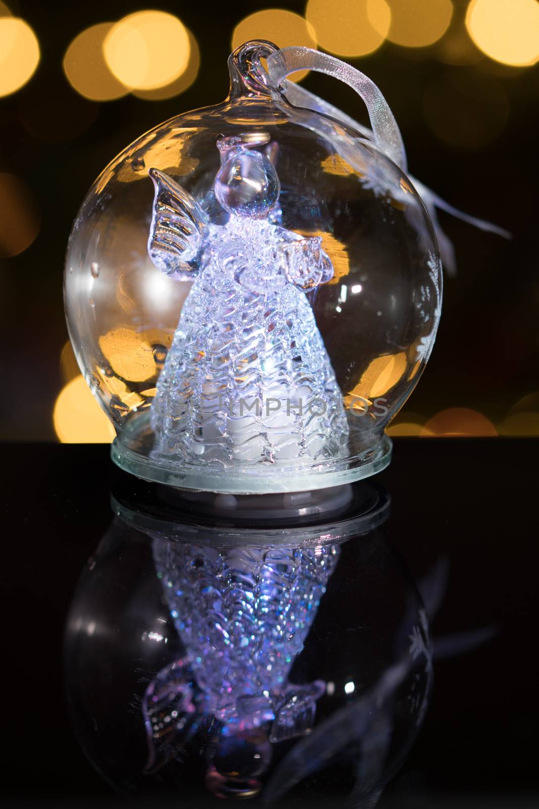 Illuminated angel figure in glass bulb, soft boke christmas ligh by asafaric