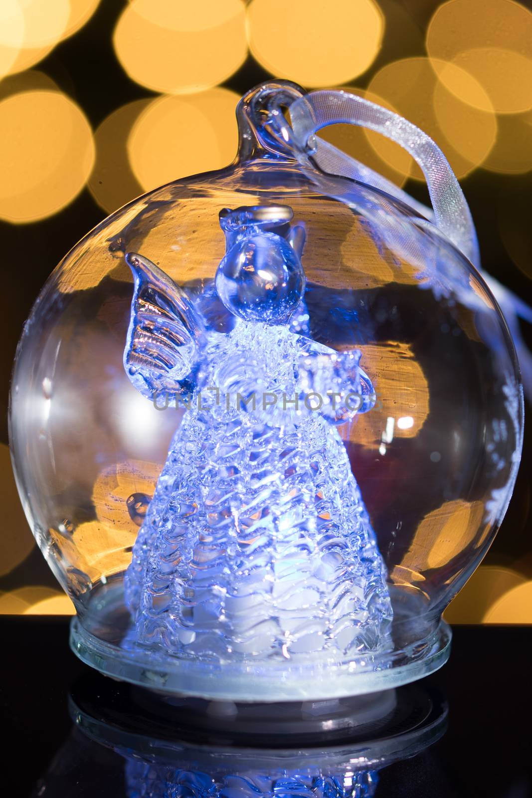 Illuminated angel figure in glass bulb, soft boke christmas ligh by asafaric