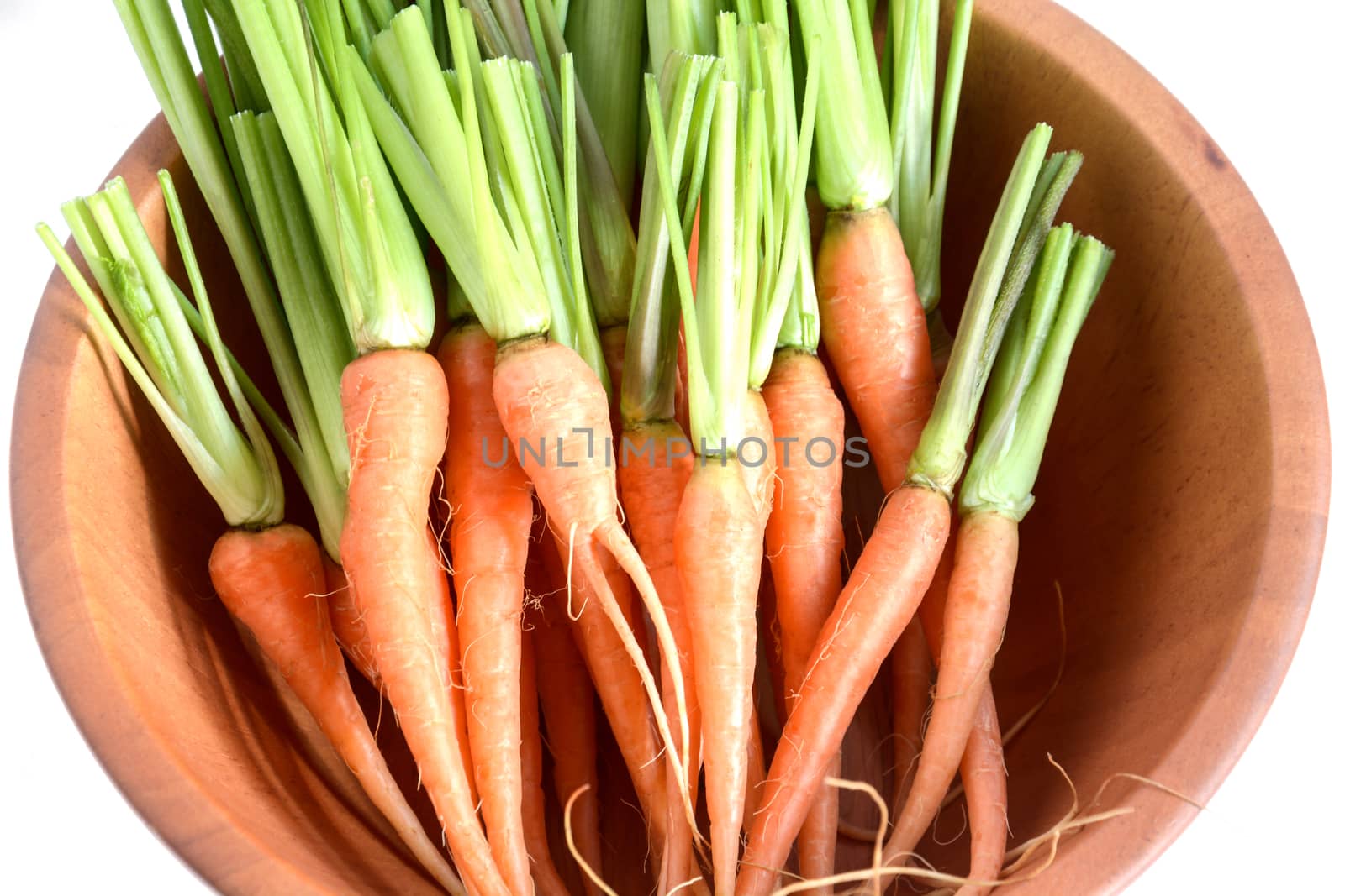 Fresh and sweet carrot in wooden bowls isolated white background by rakoptonLPN