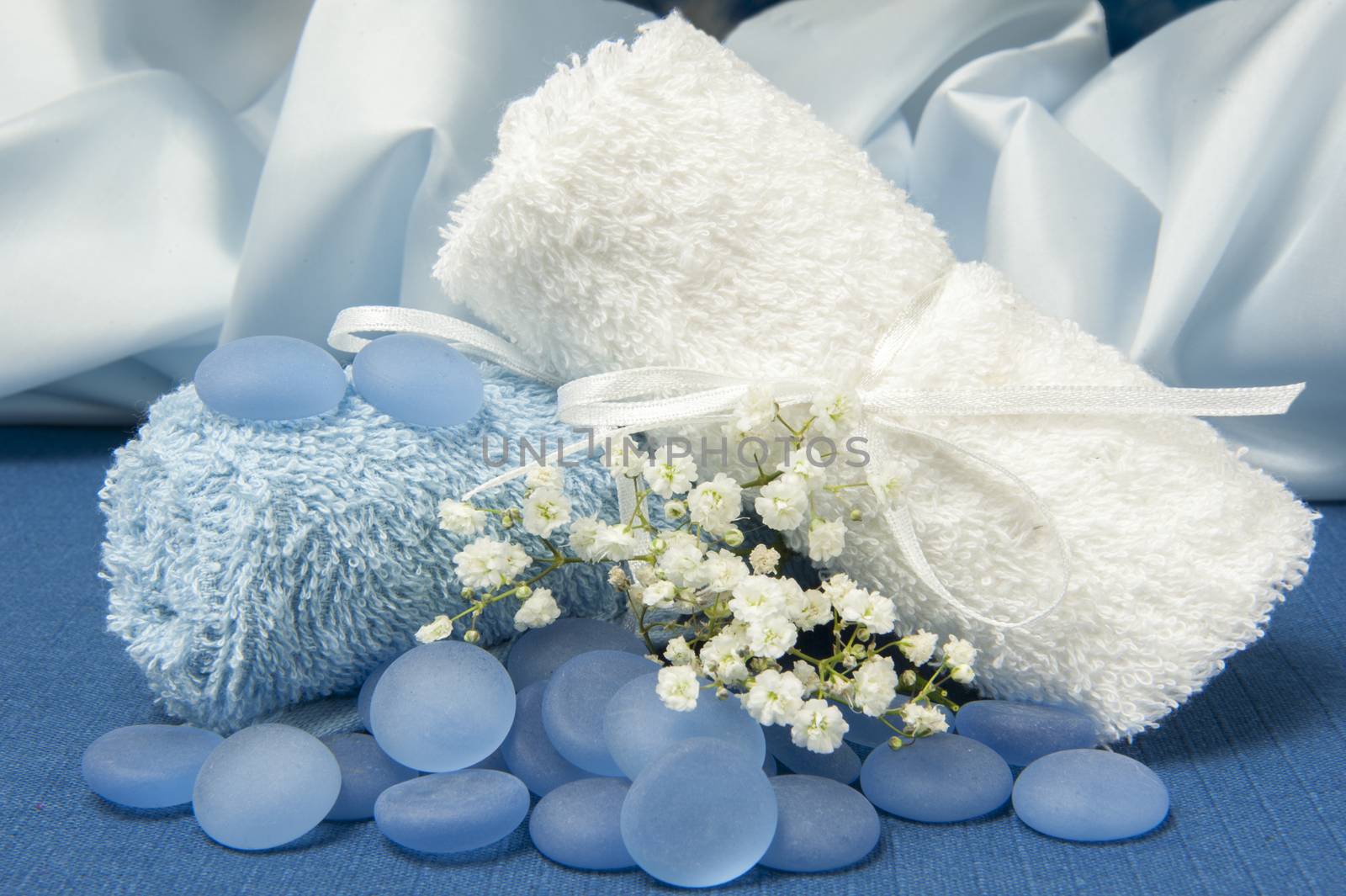 Towels and blue stones on a blue background