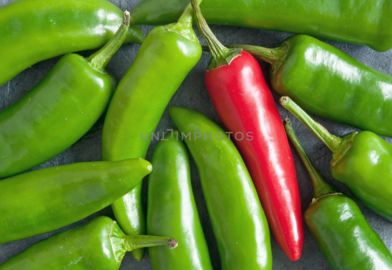 Red pepper amongst many green chillis 