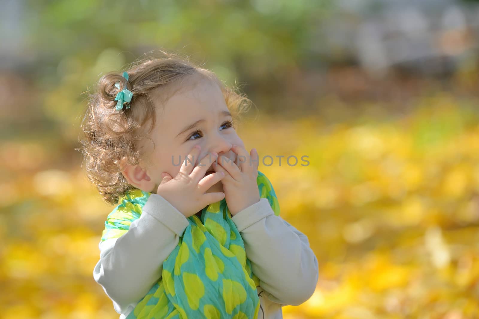 Happy little girl in autumn park