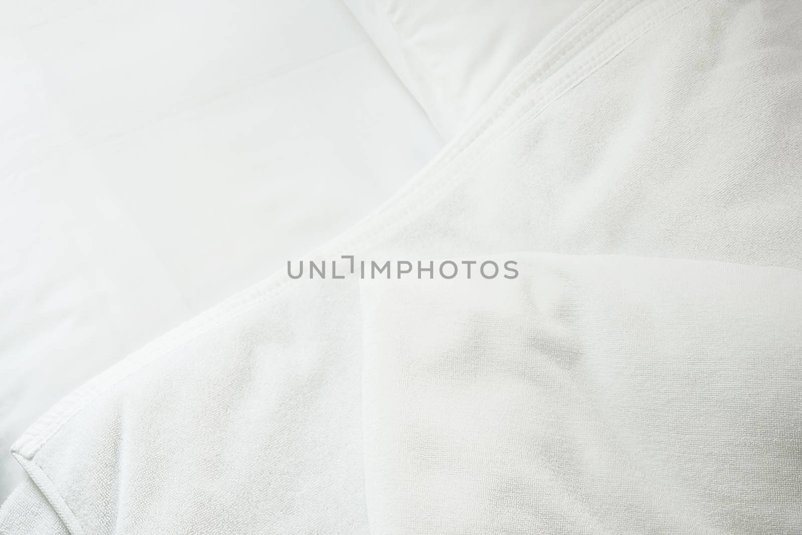 white towel on white mattress fabric, soft light in the morning