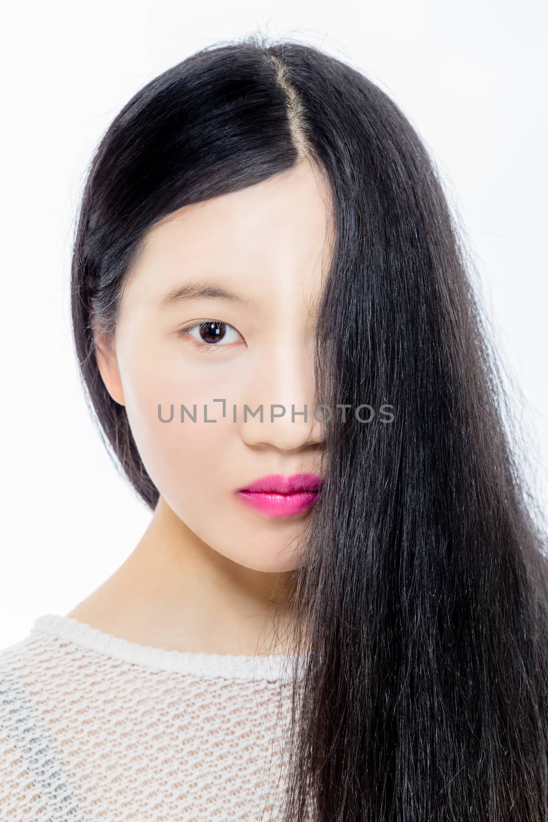 Teenage Asian American girl with hair covering half face