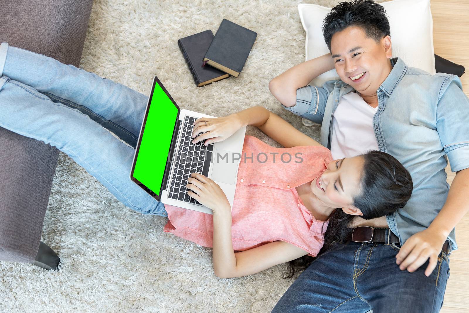 Couples lying down using laptop by vichie81
