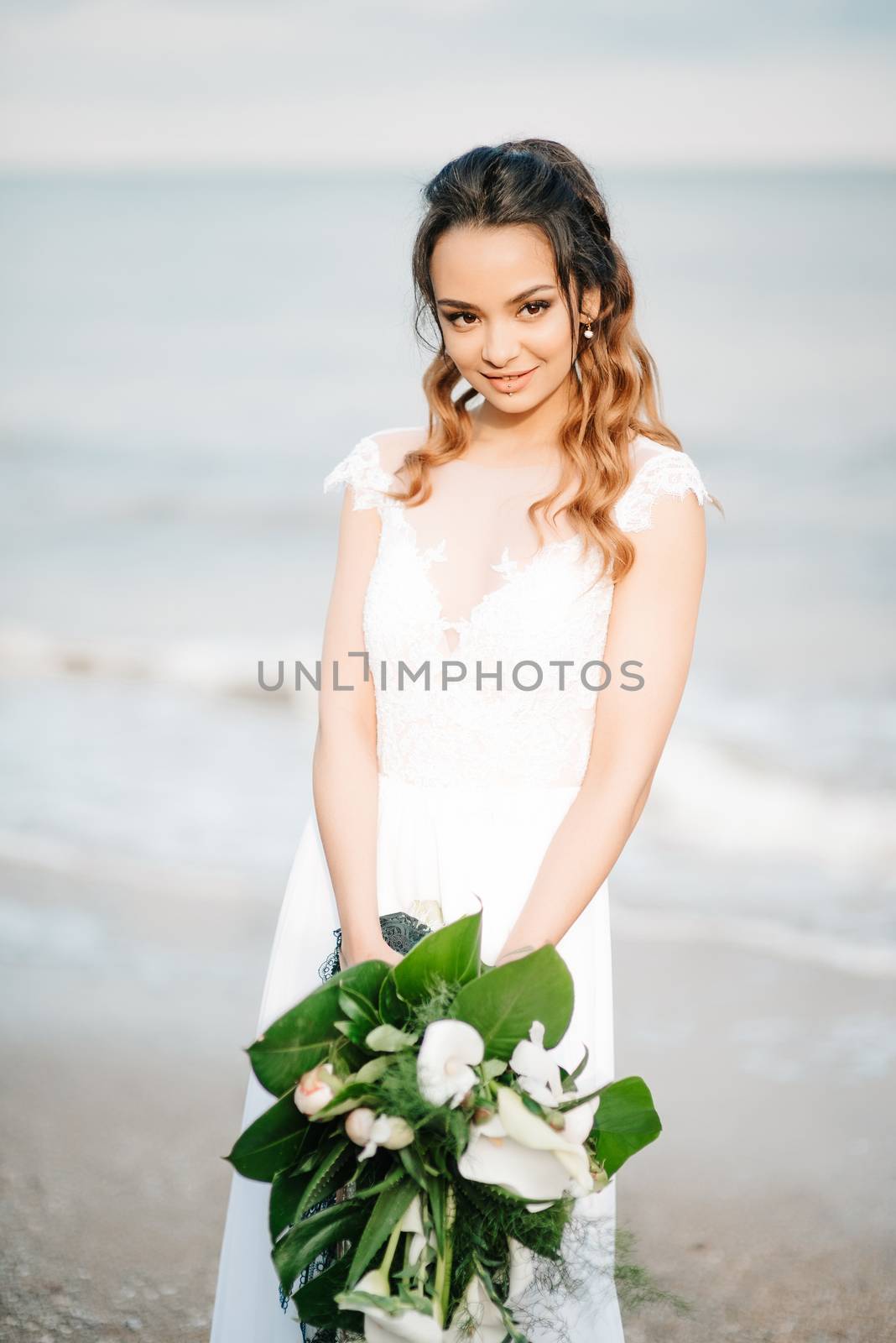 bride with a wedding bouquet on the shore  sea by Andreua