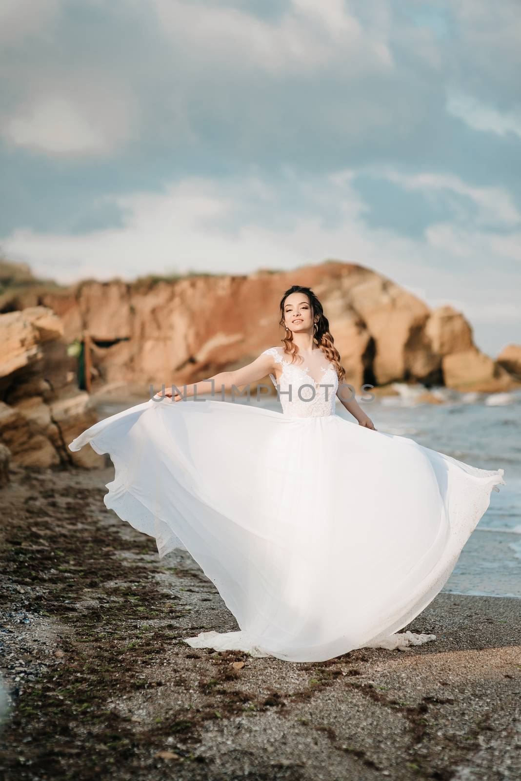 bride on the shore of the black sea in the sunset light