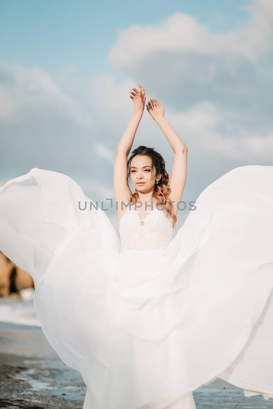 bride on the shore of the black sea in the sunset light