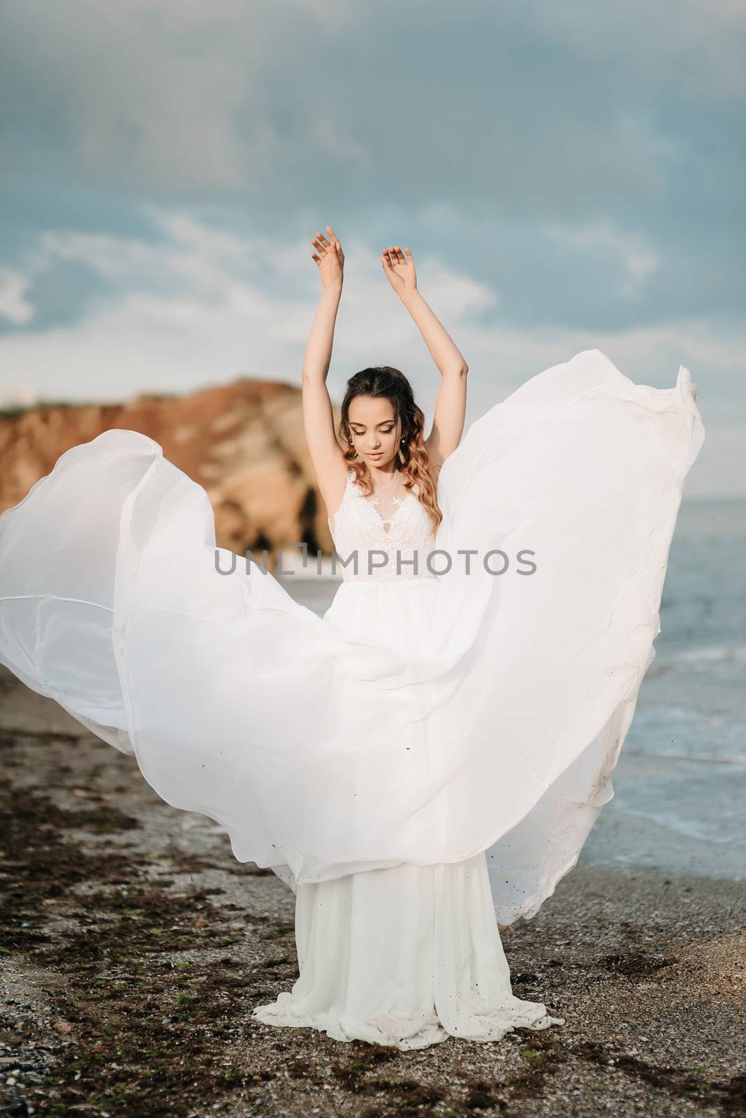 bride on the shore of the black sea in the sunset light