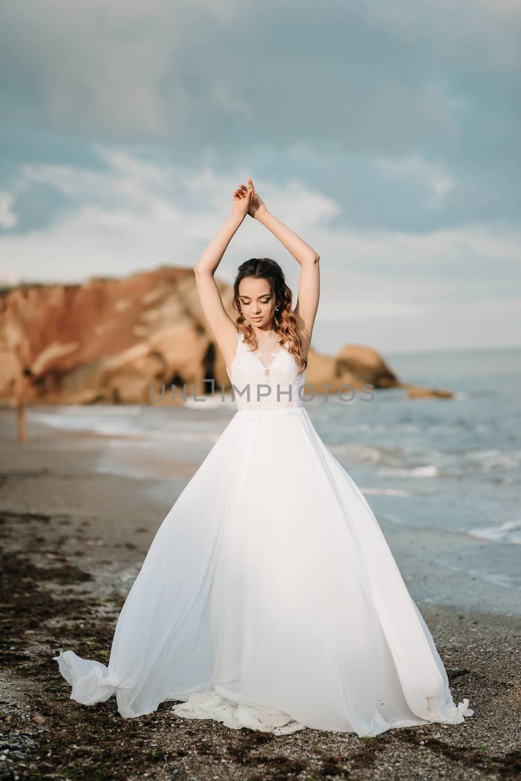 bride on the shore of the black sea in the sunset light