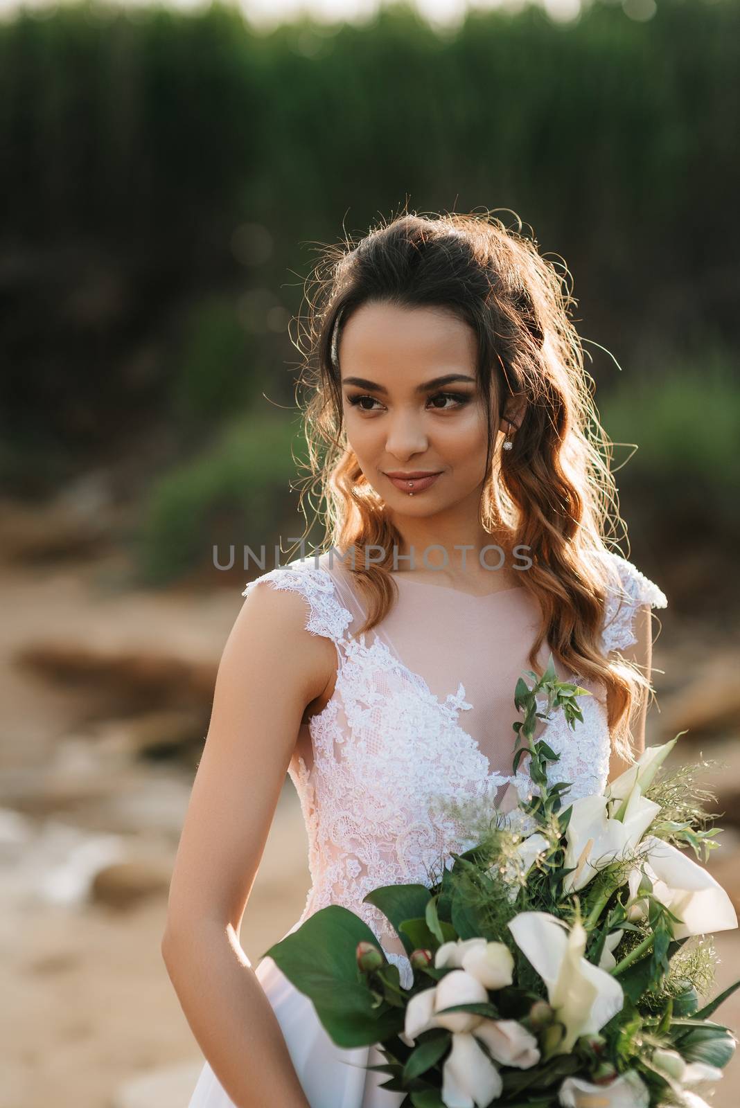 bride with a wedding bouquet on the shore  sea by Andreua