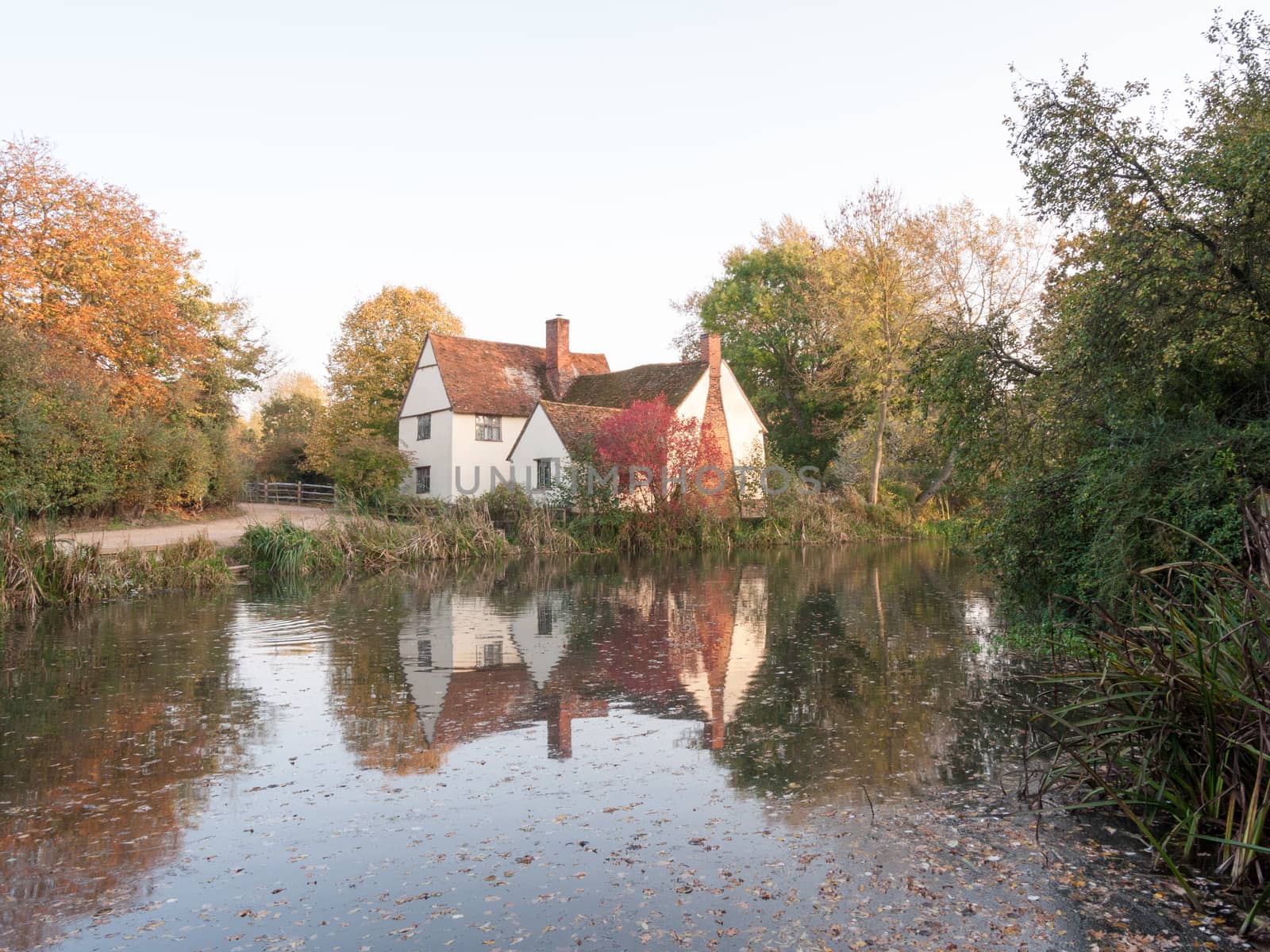 willy lotts cottage at flatford mill in suffolk in autumn reflections in lake; suffolk; england; uk