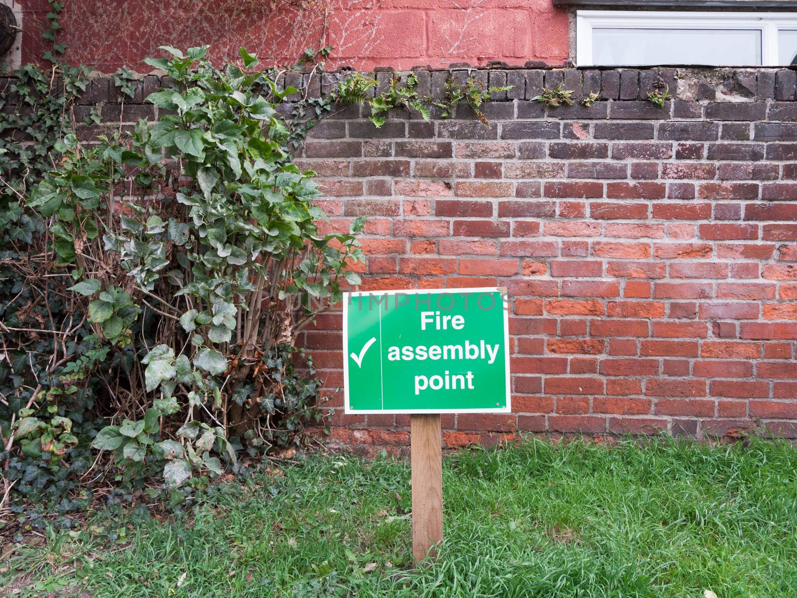 green fire assembly point wooden sign post outside safety by callumrc