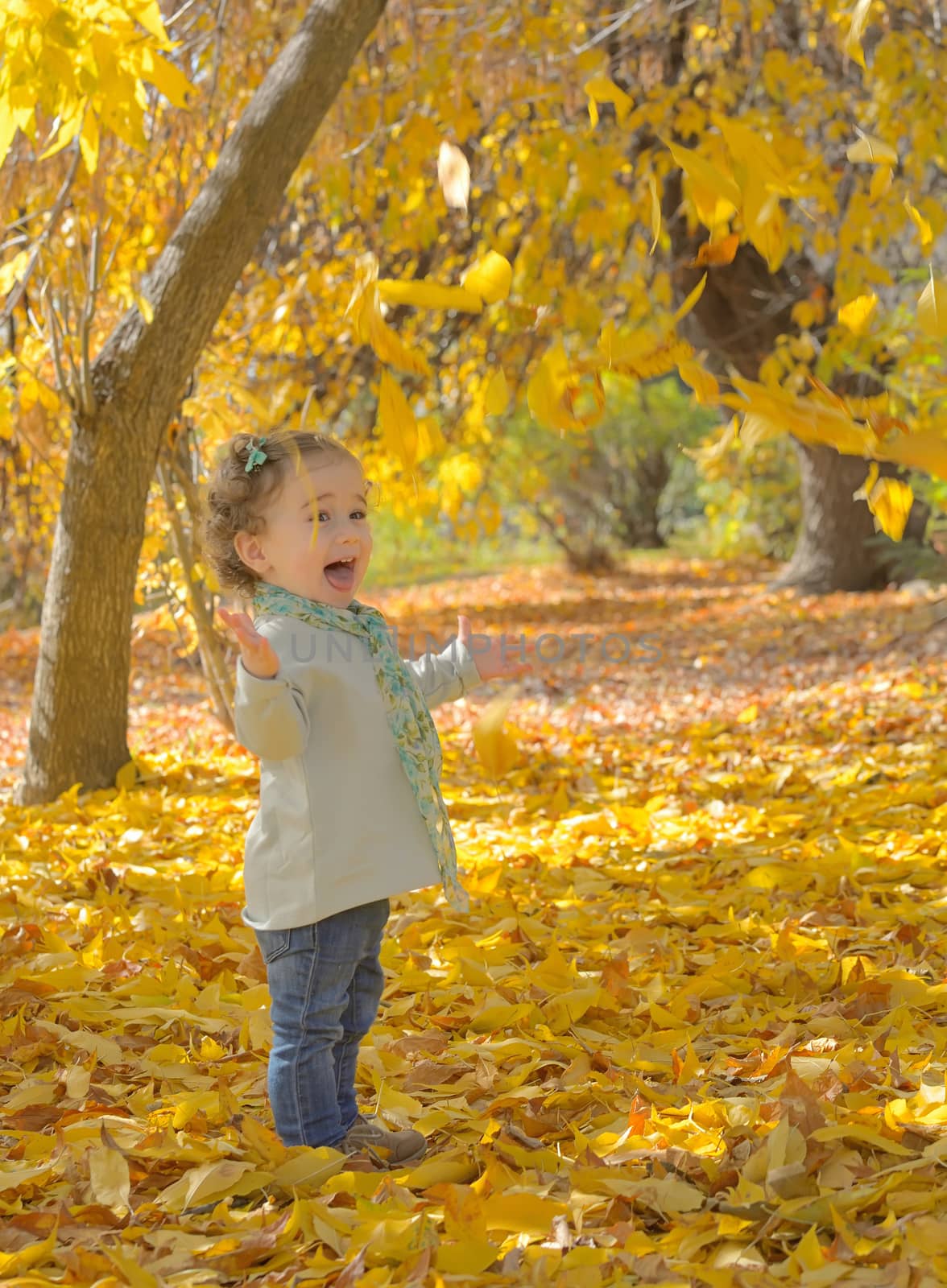 Happy little girl in autumn park