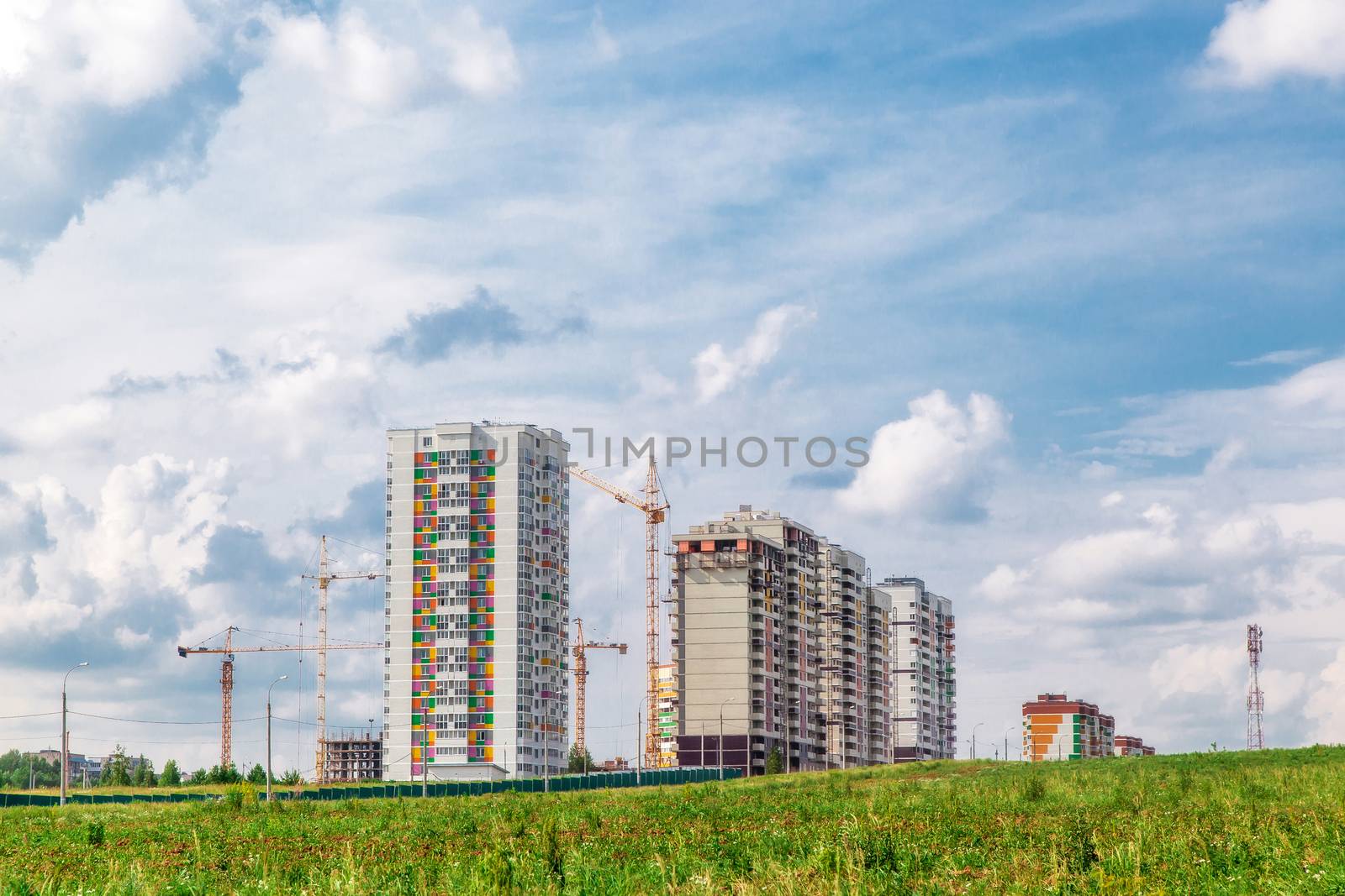 Construction of new houses near a glade in sunny day