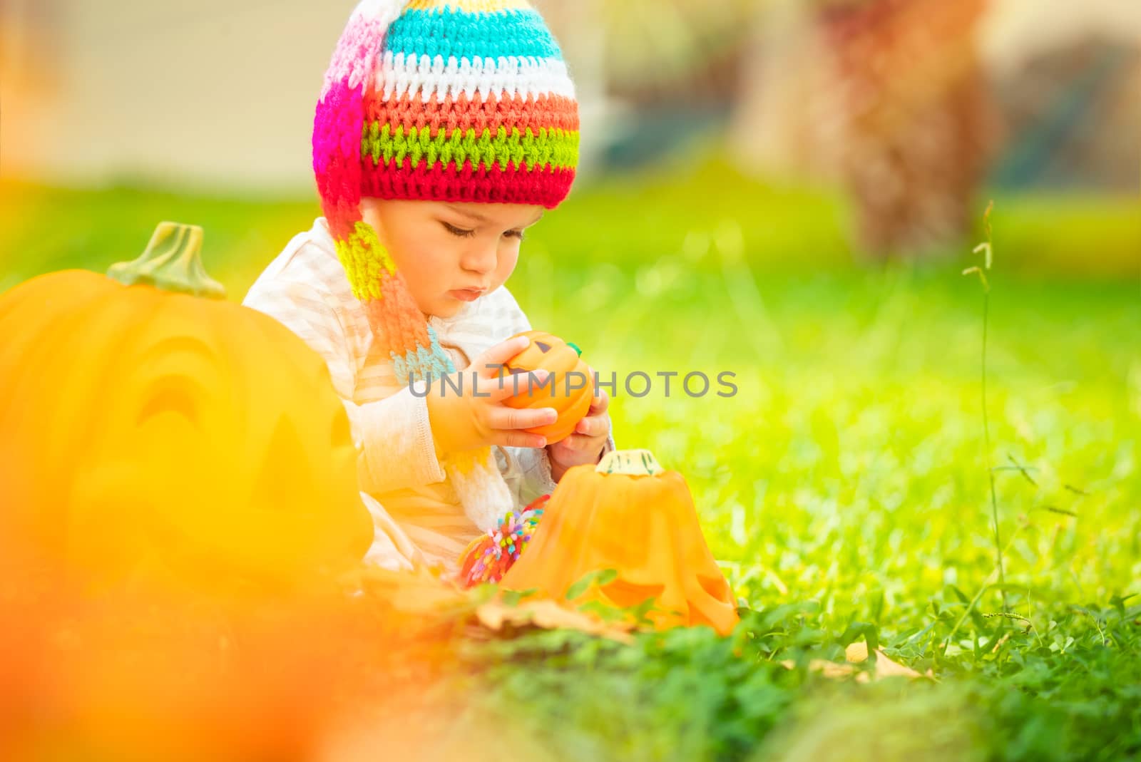 Cute baby playing with Halloween pumpkins by Anna_Omelchenko