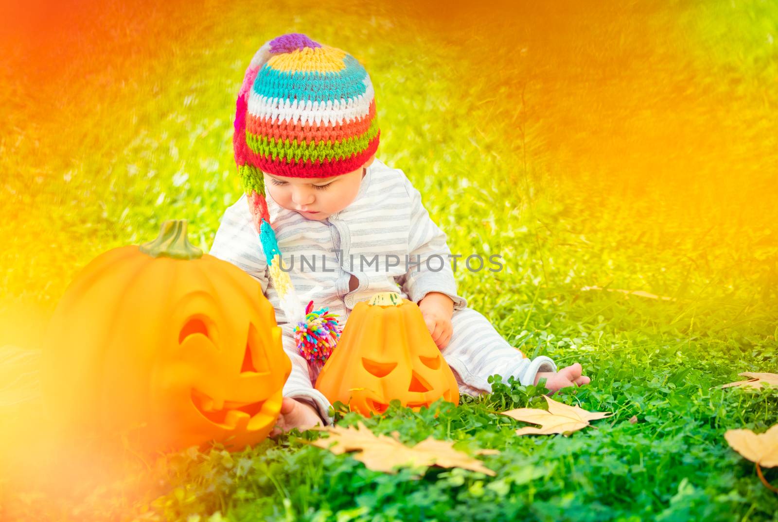 Cute baby playing with Halloween pumpkins by Anna_Omelchenko