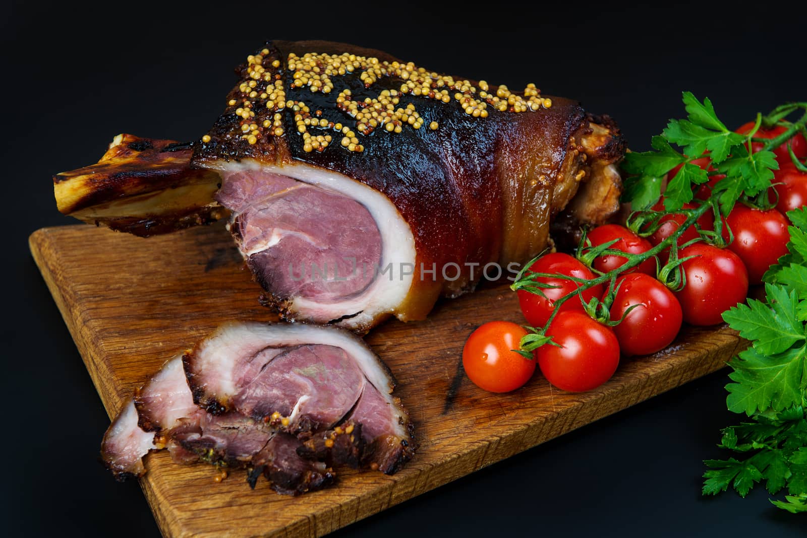 Roast pork knuckle and ingredients close-up on a slate board. Traditional european cuisine