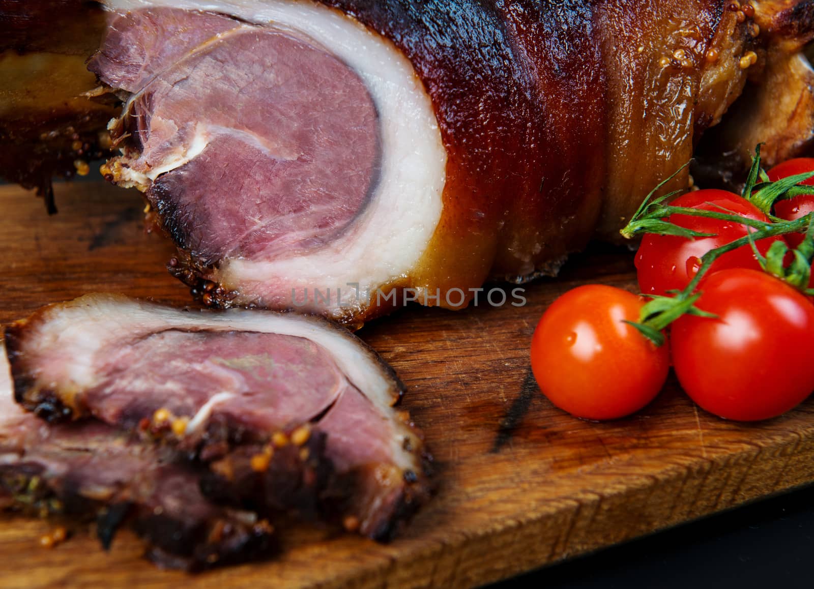 Roast pork knuckle and ingredients close-up on a slate board.  by Draw05