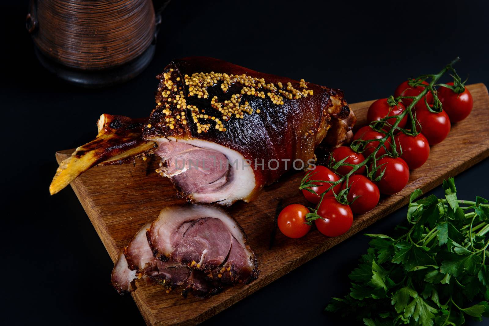 Roast pork knuckle and ingredients close-up on a slate board. Traditional european cuisine