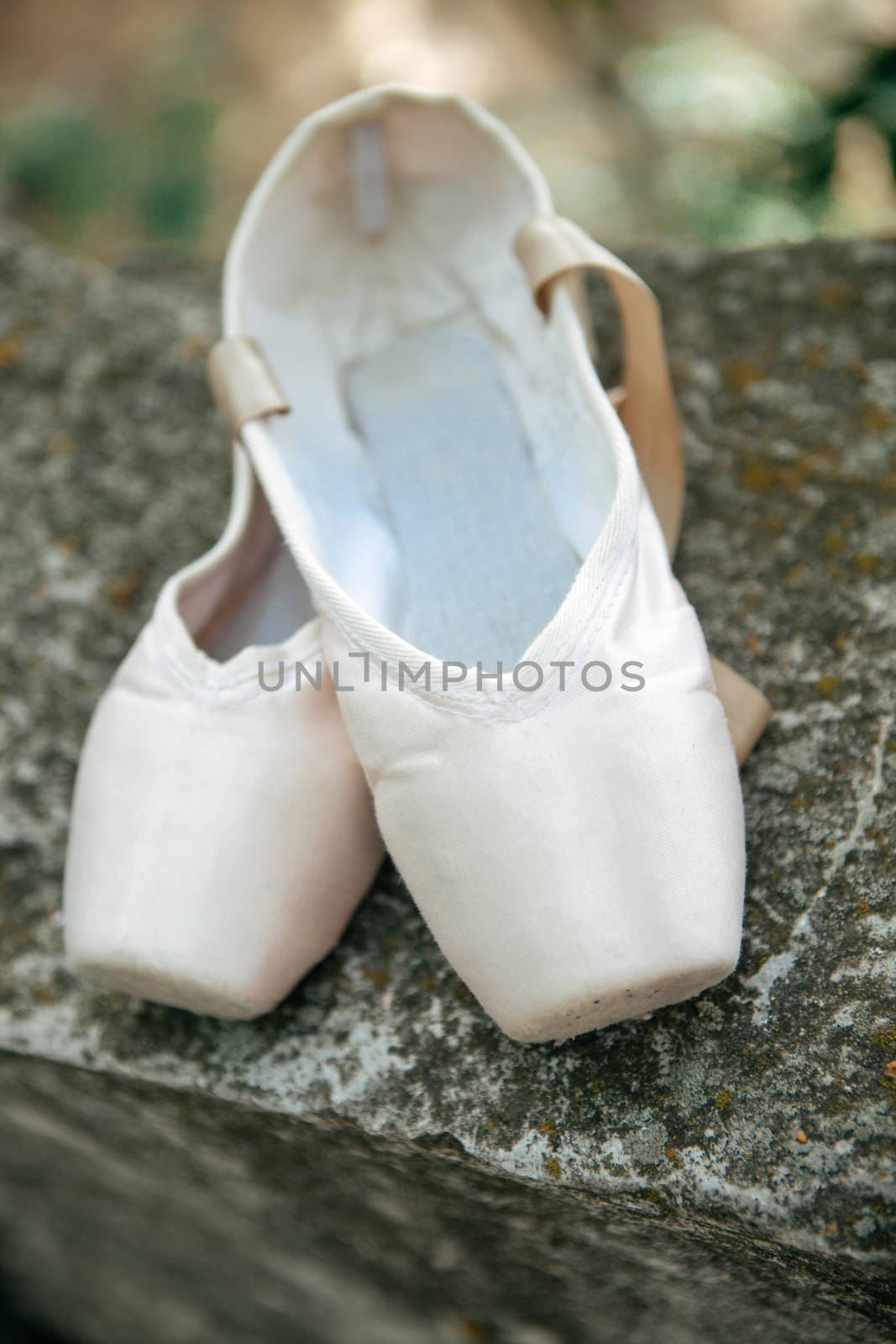 Pointe shoes for a classical ballerina, close-up on concrete by sermax55