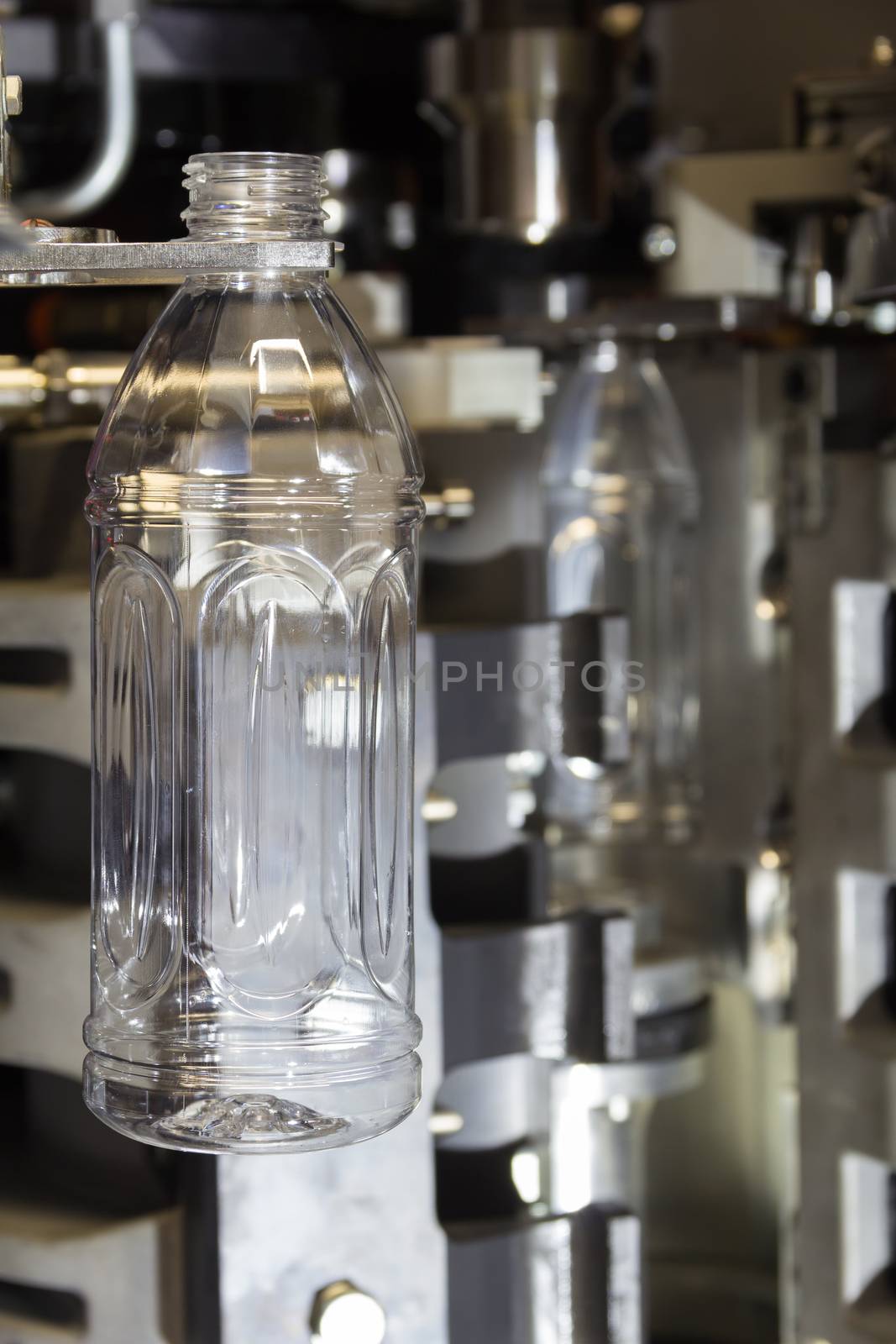PET bottles blowing. The plastic bottle blowing machine.Heating process for plastic bottle process.