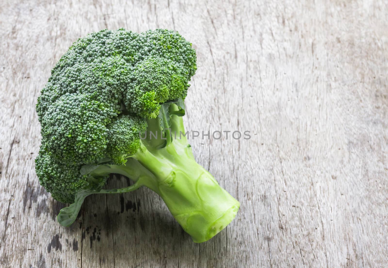 Closeup fresh broccoli on wooden background, raw food for cooking