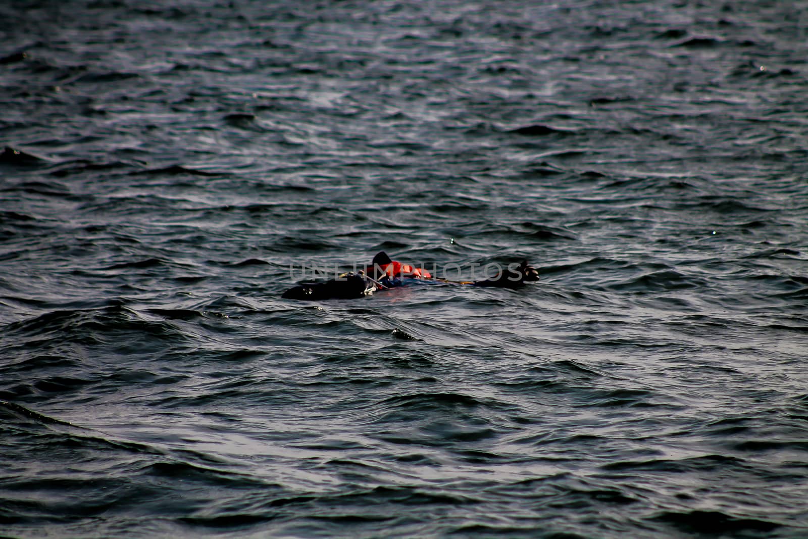 A dummy with life vest simulating a human being floating in the sea in an exercise